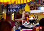 Oct. 18, 2016 -- The 11th Panchen Lama Bainqen Erdini Qoigyijabu ties safety knots for the monks. On September 10, the 11th Panchen Lama Bainqen Erdini Qoigyijabu visited the Gandanrebujie Monastery in Shigatse of China’s Tibet Autonomous Region. (Photo by Li Lin)
