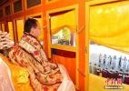 Oct. 18, 2016 -- The 11th Panchen Lama Bainqen Erdini Qoigyijabu watches the performances. (Photo by Li Lin)