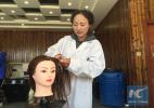Oct. 18, 2016 -- A student practices in a barbershop in Yushu on Sept. 25 . (Xinhua/Feng Qidi)