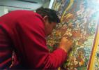 Nov. 22, 2016 -- Kelsang Dawa shows his thangka collection at his painting center in Shangri-La, Yunnan province. The Tibetan art genre is energy-intensive－sometimes it takes years to finish one piece. Photos By Wang Kaihao / China Daily