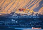 Nov. 24, 2016 -- Photo taken on Nov. 19, 2016 shows the winter scenery of Potala Palace in Lhasa, capital of southwest China`s Tibet Autonomous Region. Known as an ancient palace at high elevation, the Potala Palace was inscribed onto the world cultural heritage list in 1994.[China.org.cn/Photo by Han Jiajun]