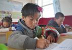 Nov. 28, 2016 -- Pupils practice calligraphy fo the Tibetan language at Daiqian school in Zhuaxixiulong Township of Tianzhu Tibetan Autonomous County, northwest China`s Gansu Province, Nov. 24, 2016. To increase the enrollment rate of schools, especially ensure Tibetan children`s access to education, about 62 schools of the county have concentrated the efforts in training teachers and attracting more competent faculties as well as improving conditions for teaching facilities. (Xinhua/Guo Gang)