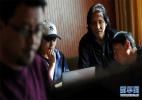 Nov. 29, 2016 -- Photo taken on Nov. 7 shows that Sonam Chodron (2nd,L) is discussing background music with composer Tashi Norbu (2nd,R) in a recording room in Lhasa.[Xinhua/Jigme Dorje]