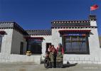 Dec. 12, 2016 -- Villagers pose for photo in front of their new house in Gyirong County of Shigatse City, southwest China`s Tibet Autonomous Region, Dec. 7, 2016. Over 16,000 people were affected by the quake which hit the county on April 25, 2015. More than 3,000 residential buildings were badly damaged. The local government has reconstructed 89.6% of houses for villagers so far. The rest will be finished by the end of the year. (Xinhua/Liu Dongjun)