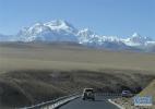 Dec. 21, 2016 -- Photo taken on Dec. 9 shows SUVs running on the road of Shigatse City, southwest China`s Tibet Autonomous Region. With an average altitude of 4000 meters, Shigatse City is vast in territory and the terrain is diverse. In winter, snow-capped mountains in this region is towering and magnificent.[Xinhua/Liu Dongjun]