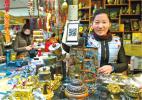 Jan.6, 2017 -- In a Tibetan handicraft store in Barkhor street, Lhasa City, the boss is showing the QR code on her cellphone. [Photo/Xinhua/Liu Dongjun]