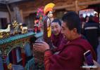 Feb. 13, 2017 -- A lama transfers a butter statue to the exhibition booth at the Taer (Gumbum) Monastery in Huangzhong County of Xining, capital of northwest China`s Qinghai Province, Feb. 11, 2017. The butter sculptures are handmade by lamas in shapes of Buddha figurines, trees, flowers, birds and animals. (Xinhua/Zhang Hongxiang)