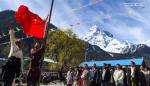 March 29,2017--Villagers attend a national flag raising ceremony in Daxing Village of Zhamog Township in Bomi County of Nyingchi, southwest China`s Tibet Autonomous Region, March 28, 2017. People here celebrated Serfs` Emancipation Day on March 28, which was designated as the day to mark the freeing of 1 million people, or 90 percent of the region`s population at that time, from the feudal serf system in 1959. (Xinhua/Purbu Zhaxi)