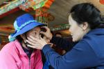 June 9, 2017 -- A doctor from Beijing examines the eyes for a woman in Gongbo`gyamda county, Nyingchi, southwest China`s Tibet Autonomous Region, June 8, 2017. More than 100 doctors from Beijing Thursday volunteered to provide medical consultations and physical examinations for people in Nyingchi. [Photo/Xinhua]