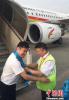 June 22,2017--On June 19th, Zhao Guoqiang (Right), general manager assistant of Tibetan Airlines and president of Himalaya Airlines, presents Hada to the crew serving in this test flight at Tribhuvan International Airport in Kathmandu. (Provided by Tibetan Airlines)