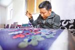 Aug. 21, 2017 -- A worker is making Drigung Embroidery Thangka in the manual workshop of Qimaka Village, Nyimajangra Town, Maizhokunggar County, Lhasa City, Tibet Autonomous Region. [Photo/China Tibet News]
