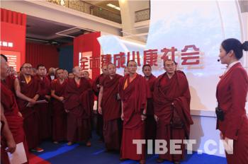 Monks visit exhibition on achievements made over last five years