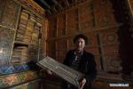 Nov. 13, 2017 -- A working staff shows the plate used for scripture printing in the ancient scripture hall of Zimai family in Zilong Village of Daocheng County, southwest China`s Sichuan Province, Nov. 8, 2017. The ancient house has scripture halls of different religious sects of Tibetan Buddhism. (Xinhua/Jiang Hongjing)
