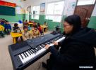 Nov. 24, 2017 -- Volunteer teacher Wu Tongyu teaches music class at Bohai Primary School in Dagcanglhamo Township, Luqu County of Gannan Tibetan Autonomous Prefecture, northwest China`s Gansu Province, Nov. 17, 2017. Since 2015, 400 college students from universities within Gansu province have been dispatched to poor and ethnic regions as volunteer teachers in Gansu every year, which have contributed to the development of all-round education in these regions. (Xinhua/Liu Jinhai)
