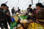 Nov. 27, 2017 -- Salesmen sell goods at a livestock products fair in Nagqu of southwest China`s Tibet Autonomous Region, Nov. 24, 2017. Local authority organized the three-day winter fair by the side of Qinghai-Tibet highway, to increase income for the herdsmen. (Xinhua/Liu Dongjun)