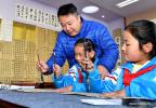Dec. 1, 2017 -- Teacher Sun Wei from China`s capital Beijing guides pupils practise calligraphy at a primary school in Lhasa, capital of southwest China`s Tibet Autonomous Region, Nov. 29, 2017. Education quality of the region has seen great improvement since a program, in which excellent teachers from other places support the region through education, was launched in 2016. (Xinhua/Zhang Rufeng)