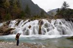 Dec. 13, 2017 -- A photographer takes a picture of Shuanglonghai Waterfall, a new scenic spot formed after the earthquake in Jiuzhaigou, Sichuan province, in November. [Hua Xiaofeng/for China Daily]