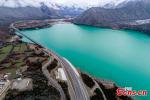 Dec. 27, 2017 -- A set of aerial photos of the Nyingchi-Lhasa highway in southwest China’s Tibet Autonomous Region following a snowfall become popular recently. With an average height of 3,000-meters, and passing through the 5,000-meter Mila Mountain, the highway resembles a road flying over the plateau. Thanks to this highway, the journey from Lhasa to Nyingchi is shortened from an 8-hour drive to 4 hours. Due to the special geographic location, the scenery on the road is diverse, and includes snow-capped mountains forests, rivers, wetlands, grasslands, farmlands and Tibetan-style village, making it the most beautiful highland road in China. (Photo: China News Service/Yang Jian)