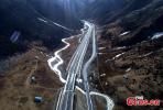 Dec. 27, 2017 -- A set of aerial photos of the Nyingchi-Lhasa highway in southwest China’s Tibet Autonomous Region following a snowfall become popular recently. With an average height of 3,000-meters, and passing through the 5,000-meter Mila Mountain, the highway resembles a road flying over the plateau. Thanks to this highway, the journey from Lhasa to Nyingchi is shortened from an 8-hour drive to 4 hours. Due to the special geographic location, the scenery on the road is diverse, and includes snow-capped mountains forests, rivers, wetlands, grasslands, farmlands and Tibetan-style village, making it the most beautiful highland road in China. (Photo: China News Service/Yang Jian)