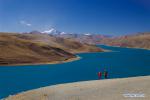 Jan. 2, 2018 -- Tourists visit the Yamzbog Yumco Lake in Nagarze County of Shannan City, southwest China`s Tibet Autonomous Region, Dec. 31, 2017. The Yamzbog Yumco Lake is one of the region`s three largest sacred lakes. (Xinhua/Liu Dongjun)