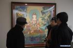 Jan. 18, 2018 -- Visitors view Thangka, or the Tibetan art of scroll painting, from northwest China`s Qinghai province, at the National Art Museum of China in Beijing, Jan. 17, 2018. (Xinhua/Lu Peng)