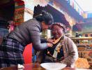 A woman helps an elder to wear traditional jewelry in Chusong Village of Nyarixung Township in Xigaze City, southwest China`s Tibet Autonomous Region, Jan. 17, 2018. In Xigaze and other farming regions of Tibet, people celebrate New Year on the 1st day of the twelfth month of the Tibetan lunar calendar. According to local farming tradition, spring ploughing season always begins as the fall of New Year, thus celebrating one month earlier is to meet the needs of local agriculture. (Xinhua/Jigme Dorje)