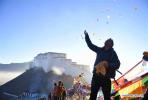 Jan. 22, 2018 -- A man throws prayer flags in the air in Xigaze, southwest China`s Tibet Autonomous Region, Jan. 19, 2018. Local people of Tibetan ethnic group have replaced prayer flags by new ones on the mountain and houses to celebrate New Year under the Tibetan calendar. (Xinhua/Jigme Dorge)