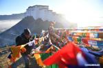 Jan. 22, 2018 -- People replace new prayer flags in Xigaze, southwest China`s Tibet Autonomous Region, Jan. 19, 2018. Local people of Tibetan ethnic group have replaced prayer flags by new ones on the mountain and houses to celebrate New Year under the Tibetan calendar. (Xinhua/Jigme Dorge)