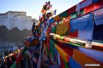 Jan. 22, 2018 -- People replace new prayer flags in Xigaze, southwest China`s Tibet Autonomous Region, Jan. 19, 2018. Local people of Tibetan ethnic group have replaced prayer flags by new ones on the mountain and houses to celebrate New Year under the Tibetan calendar. (Xinhua/Jigme Dorge)