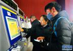 Jan. 30, 2018 -- A worker of the Lhasa Railway Station (M) is helping a passenger to use the automatic fetching machine, January 26. [Photo/Xinhua]
