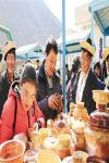 Feb. 11, 2018 -- Photo shows people buying wooden bowls at the New Year market of Nyingchi City. [Photo/China Tibet News/Pan Lu]
