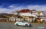 Feb. 24, 2018 -- A gas-electric hybrid bus runs in front of the Potala Palace in Lhasa, capital of southwest China`s Tibet Autonomous Region, Feb. 11, 2018. Lhasa has put 128 new gas-electric hybrid buses on the road at the beginning of this year, making the number of new-energy buses to 312, or 60 percent of the city`s public bus fleet,local authorities said Friday.(Xinhua/Yang Meiduo)