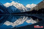 Feb. 28, 2018 -- Ranwu Lake is one of the largest lake in eastern Tibet. The Lagu Glacier is located in the north side of Ranwu Lake, where the snow melts injecting into the lake. The smooth surface of the lake was like a mirror. The placid lake reflected the golden snow mountains at sunrise and the stars at night.(Photo/Ma Qian)