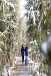 Mar. 22, 2018 -- Photo shows two residents are wandering in the Nanshan Park after the strongest snowfall since last year`s winter arrives in Lhasa, capital city of southwest China`s Tibet in the evening of March 17, 2018.