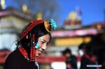 Mar. 29, 2018 -- A female pilgrim prepares to enter the Jokhang Temple in Lhasa, capital of southwest China`s Tibet Autonomous Region, Jan. 26, 2018. Many pilgrims came to Lhasa to pray for harvests and prosperity ahead of the Tibetan New Year. (Xinhua/Chogo)