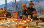 April 17, 2018 -- A man shows handmade wooden bowls during a kick-off ceremony for tourism season in Gongbo`gyamda County, southwest China`s Tibet Autonomous Region, April 15, 2018. (Xinhua/Liu Dongjun)