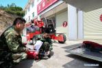 May 12, 2018 -- Fire services officer Jiang Yuhang (R) and technician Wang Gang check the firefighting equipment in Kaili City, southwest China`s Guizhou Province, May 8, 2018. On May 17, 2008, Jiang, a 20-year-old highway administration employee, was extricated by firefighters, 123 hours after he was trapped in the rubble at quake-hit Yingxiu Township of Wenchuan County, southwest China`s Sichuan Province. Jiang was a survivor of the 8.0-magnitude earthquake that struck Sichuan`s Wenchuan County on May 12, 2008. The quake left more than 69,000 dead, 374,000 injured, 18,000 missing and millions homeless. Jiang said it were firefighters who gave him the second life, and he desired to be a soldier like them. At the end of 2008, Jiang realized his dream to join the army and served in the group who once saved him. After training for half a year, he finally became a real fire soldier in Shanghai in 2009. Jiang later got promoted to the position of an officer, and in March this year, he was transferred to the firefighting force in his hometown Kaili City, southwest China`s Guizhou Province. In the past ten years, the young man, who was saved in that catastrophic earthquake, saved more people`s lives with his own efforts. (Xinhua/Jiang Hongjing)