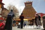 May 29,2018--Buddhists pray in front of the Kanjur stone stupa. 