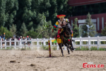 Aug.15,2018--An equestrian puts on a display of traditional horsemanship skills during the Shoton Festival, commonly known as the Yogurt Festival, in Lhasa, Southwest China’s Tibet Autonomous Region, Aug. 13, 2018. Equestrians performed ten kinds of stunts while riding a horse, including archery and toasting. (Photo: China News Service/He Penglei)