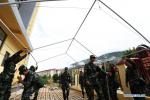 Oct. 15, 2018 -- Armed police help to set up tents for relocated residents in Deqen Tibetan Autonomous Prefecture, southwest China`s Yunnan Province, Oct. 14, 2018. To cope with a flood peak from the leakage of a landslide-caused barrier lake on the upper reaches of the Jinsha River, local government has safely relocated a total of 8,455 residents living along the possibly affected area in Deqen with relief materials orderly distributed. (Xinhua)