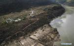 Oct. 22, 2018 -- Aerial photo taken on Oct. 20, 2018 shows roads leading to Jiala Village revealed after an overflow from a landslide-caused barrier lake in Menling County, southwest China`s Tibet Autonomous Region. Water levels are dropping after an overflow at a barrier lake formed after a landslide in the Yarlung Tsangpo River in southwest China`s Tibet Autonomous Region, local officials said Friday. TO GO WITH: Water level in Tibet barrier lake drops after overflow(Xinhua/Purbu Zhaxi)