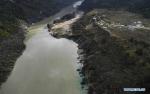 Oct. 22, 2018 -- Aerial photo taken on Oct. 20, 2018 shows the Jiala Village by the Yarlung Tsangpo River after an overflow from a landslide-caused barrier lake on the river in Menling County, southwest China`s Tibet Autonomous Region. Water levels are dropping after an overflow at a barrier lake formed after a landslide in the Yarlung Tsangpo River in southwest China`s Tibet Autonomous Region, local officials said Friday. TO GO WITH: Water level in Tibet barrier lake drops after overflow(Xinhua/Purbu Zhaxi)
