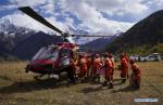 Oct. 22, 2018 -- Rescuers load a helicopter with relief materials for the lanslide-caused barrier lake disaster area in Menling County, southwest China`s Tibet Autonomous Region, on Oct. 20, 2018. A helicopter from Xilin Fengteng General Aviation Co., Ltd. took part in the disaster relief to transport relief materials. The barrier lake was formed near a village in Menling County after landslides on Wednesday and Thursday blocked the Yarlung Tsangpo River`s waterway. (Xinhua/Purbu Zhaxi)