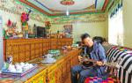 Nov.16,2018--Photo shows a local villager of “Happy Farmhouse” playing Tibetan traditional string instrument in Dadong Village. [China Tibet News/Lu Lijuan]
