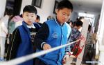 Dec. 3, 2018 -- A pupil from Shanghai takes part in a robot contest during the 15th Shanghai Future Engineer Competition in Shanghai, east China, Dec. 1, 2018. More than 1,600 students from Shanghai and Xigaze of southwest China`s Tibet Autonomous Region took part in the competition, which opened here on Saturday. (Xinhua/Fang Zhe)