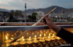 Dec. 4, 2018 -- A monk lights butter lamps at the Jokhang Temple in Lhasa, capital of southwest China`s Tibet Autonomous Region, Dec. 2, 2018. People of the Tibetan ethnic group lit butter lamps and prayed through the night in the annual Butter Lamp Festival commemorating Tsong Khapa, a master of Tibetan Buddhism. (Xinhua/Purbu Zhaxi)