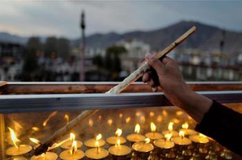 People light butter lamps to commemorate master of Tibetan Buddhism