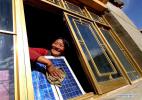 Dec. 7, 2018 -- A woman cleans a solar panel at her new house thanks to the `Guangming` Project, which was drived by the Chinese government in 1997 to solve the power supply of no-electricity regions by developing new energy electricity generation, in southwest China`s Tibet Autonomous Region, Oct. 12, 2006. China has been delivering on its commitment to the international community on climate change by continuously shifting to a more green economy over the past years. New energy-rich regions like Inner Mongolia and Ningxia are sending more electricity generated from clean energy to the country`s bustling east to help reduce the country`s heavy reliance on coal in the fight against pollution and coping with climate change. China is also a leader in new energy vehicles (NEVs), with many regions across the country moving to replace their traditional gasoline-powered buses and taxis with green-energy vehicles. The country has been the world`s largest NEV market for three consecutive years, with some 777,000 NEVs sold in 2017 alone. Sales in the first 10 months of this year jumped 75.6 percent year on year to 860,000 units. Thanks to increased investment in green energy, China`s carbon intensity, or the amount of carbon dioxide emissions per unit of GDP, in 2017 had declined by 46 percent from 2005 levels, meeting the target ahead of schedule of a 40-45 percent drop by 2020, according to the Chinese Ministry of Ecology and Environment. [Photo/Xinhua]