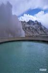 Jan. 8, 2019 -- Photo taken on Jan. 3, 2019 shows a hot spring and a snow mountain in Yangbajain Town of Damxung County, southwest China`s Tibet Autonomous Region. The first Yangbajain hot spring tourism season opened here on Thursday. (Xinhua/Purbu Zhaxi)