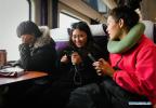 Jan. 14, 2019 -- Two students of Tibetan ethnic group are seen on the train of Z6802 from Lhasa to Xining on Jan. 11, 2019. As the Chinese Lunar New Year is drawing near, the train of Z6802 from Lhasa of southwest China`s Tibet Autonomous Region to Xining of northwest China`s Qinghai Province is crowded with tourists, workers, students and pilgrims. (Xinhua/Liu Dongjun) 